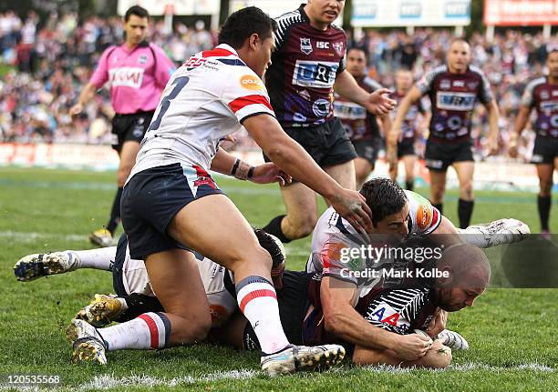 Glenn Stewart of the Sea Eagles dives over to score a try during the round 22 NRL match between the Manly Warringah Sea Eagles and the Sydney...