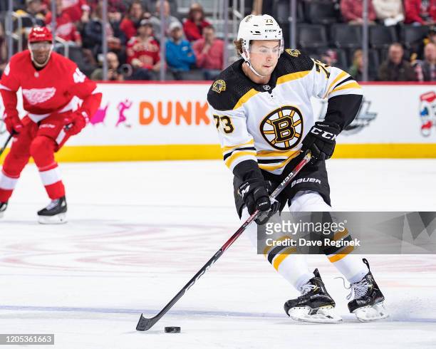 Charlie McAvoy of the Boston Bruins controls the puck against the Detroit Red Wings during an NHL game at Little Caesars Arena on February 9, 2020 in...
