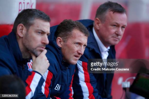 Stoke City management team, from left, Rory Delap, Billy McKinlay and Michael O'Neill look on during the Sky Bet Championship match between Stoke...