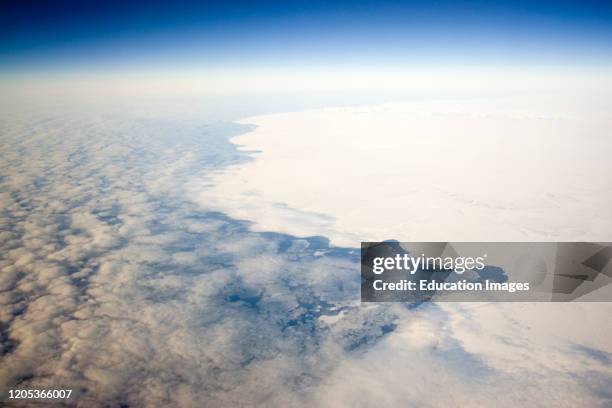 Land and ice give way to Bering Sea aerial view of winter Alaska USA.