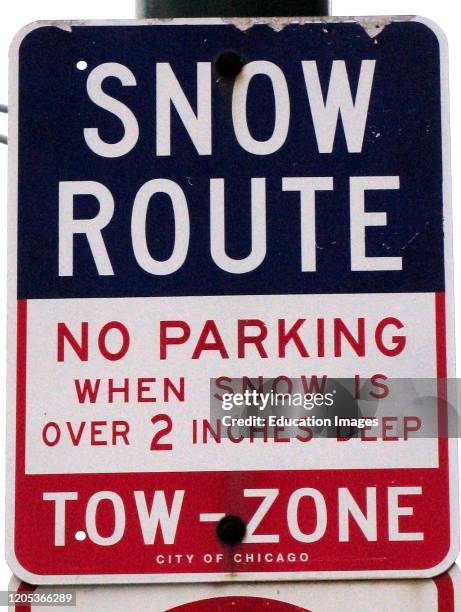 No Parking in two inches of snow or more downtown Chicago road sign USA.