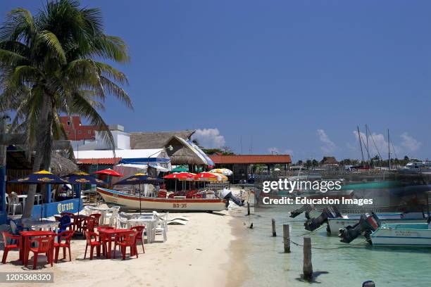 Boats at the beach jetty Isla Mujeres Mexico.