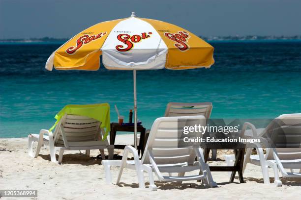 Sun beds and umbrella Playa Sol Isla Mujeres Mexico.