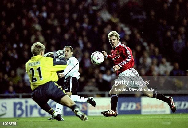 David Beckham of Manchester United one on one with Derby County keeper Mart Poom during the FA Carling Premiership match at Pride Park in Derby,...