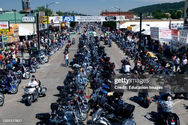 Parked motorcycles line street annual Sturgis Rally South Dakota USA.