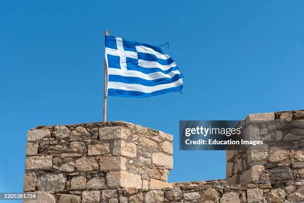 Ierapetra, Crete, Greece, The Greek flag flying from the fortress wall in Ierapetra, Crete.