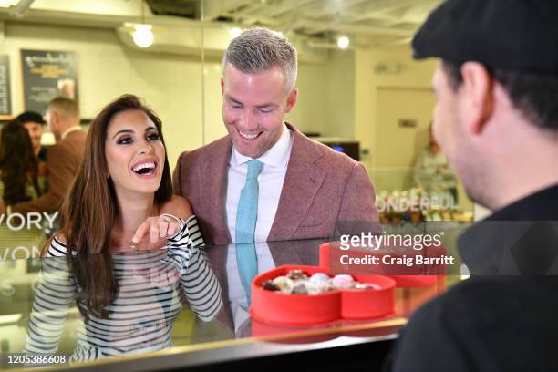 Million Dollar Listing New York stars, Ryan Serhant and Emilia Bechrakis Serhant, shop for Valentine’s Day gifts at the GODIVA café located in NYC’s...