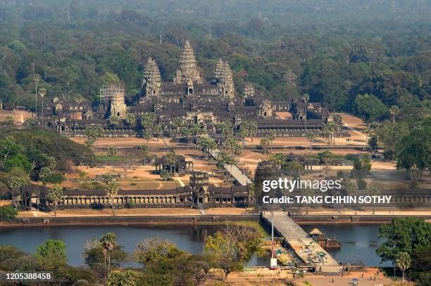 This picture taken on March 5, 2020 shows an aerial view of Angkor Wat temple in Siem Reap province. - The deadly COVID-19 novel coronavirus epidemic...