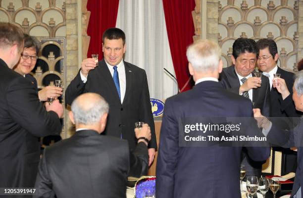 Estonian Prime Minister Juri Ratas and Japanese Prime Minister Shinzo Abe toast glasses during their dinner at the prime minister's official...