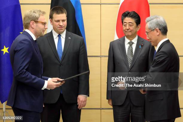 Estonian Prime Minister Juri Ratas and Japanese Prime Minister Shinzo Abe attend a signed document exchange ceremony following their meeting at the...