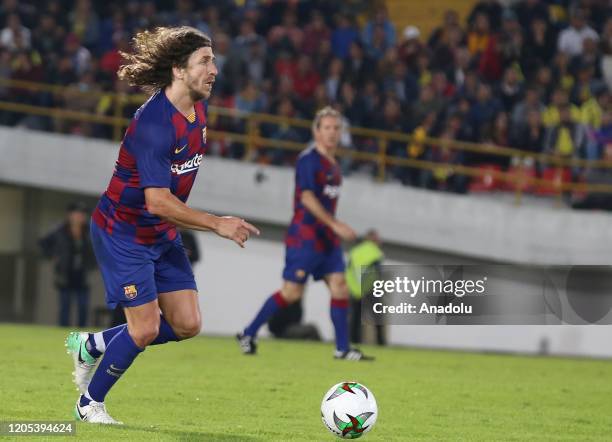 Former Spanish soccer player from Barca Legends Carles Puyol controls the ball against Colombia Legends during a friendly match at El Campin stadium...