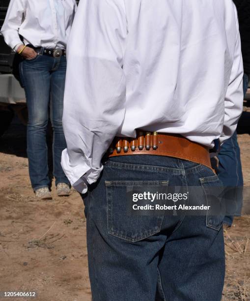 Member of a group calling theselves 'Cowboys for Trump' prepares to ride his horse with other Donald Trump supporters through the streets of downtown...