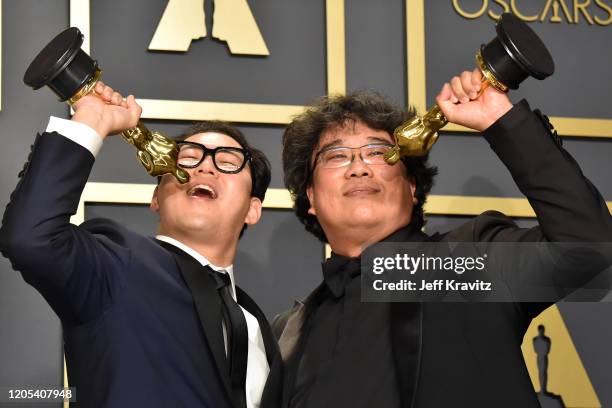 Screenwriter Han Jin-won and writer-director Bong Joon-ho, winners of the Original Screenplay award for "Parasite," pose in the press room during the...