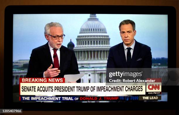 Television screen shot during live CNN coverage of the President Donald Trump impeachment trial on February 5 shows CNN news anchors Wolf Blitzer and...