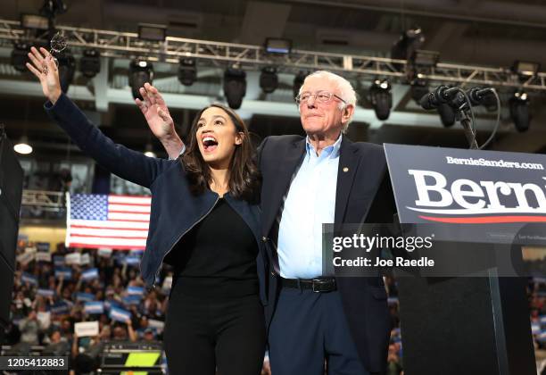 Rep. Alexandria Ocasio-Cortez and Democratic presidential candidate Sen. Bernie Sanders stand together during his campaign event at the Whittemore...