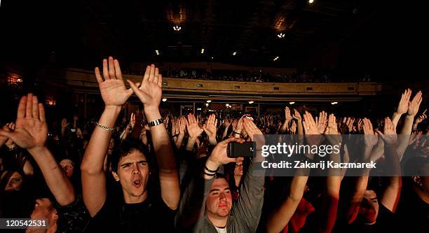 Members of the audience raise their hands as the Wu -Tang Clan performs live on stage at the Enmore Theatre on August 4, 2011 in Sydney, Australia.