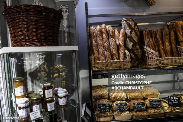 This picture shows baguettes de tradidion baked by Taieb Sahal and other breads at the Les saveurs de Pierre Demours bakery in Paris on March 6 a day...