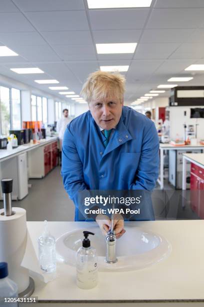 Prime Minister Boris Johnson washes his hands during a visit to the Mologic Laboratory in the Bedford technology Park on March 06, 2020 in Bedford,...