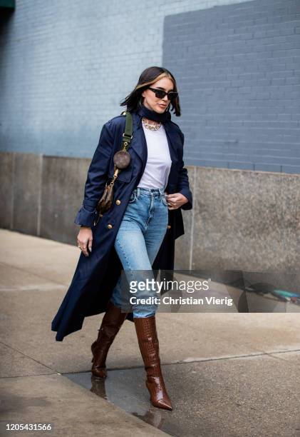 Brittany Xavier is seen wearing trench coat, denim jeans, brown boots, Louis Vuitton bag outside Jonathan Simkhai during New York Fashion Week Fall /...
