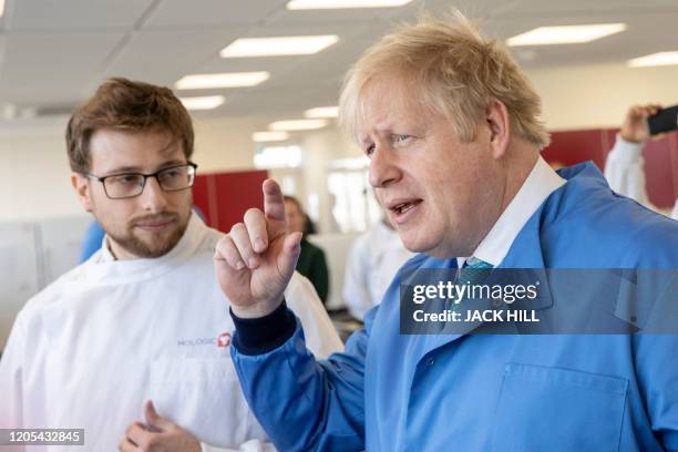 Britain's Prime Minister Boris Johnson gestures during a visit to the Mologic Laboratory in the Bedford technology Park, north of London on March 6,...