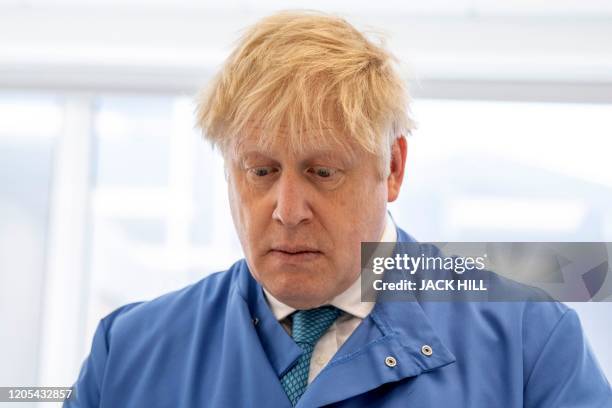 Britain's Prime Minister Boris Johnson gestures during a visit to the Mologic Laboratory in the Bedford technology Park, north of London on March 6,...