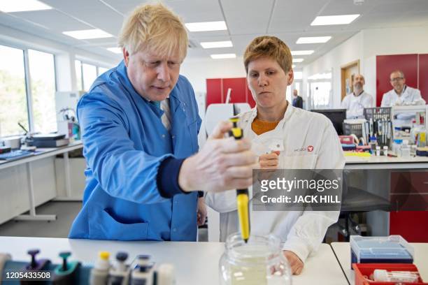 Britain's Prime Minister Boris Johnson visits to the Mologic Laboratory in the Bedford technology Park, north of London on March 6, 2020. The Prime...