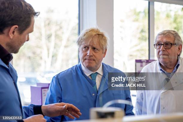 Britain's Prime Minister Boris Johnson visits to the Mologic Laboratory in the Bedford technology Park, north of London on March 6, 2020. The Prime...