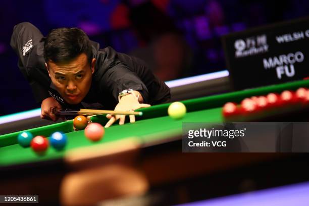 Marco Fu Ka-chun of Hong Kong plays a shot during the 1st round match against Ding Junhui of China on day one of the 2020 ManBetX Welsh Open at the...