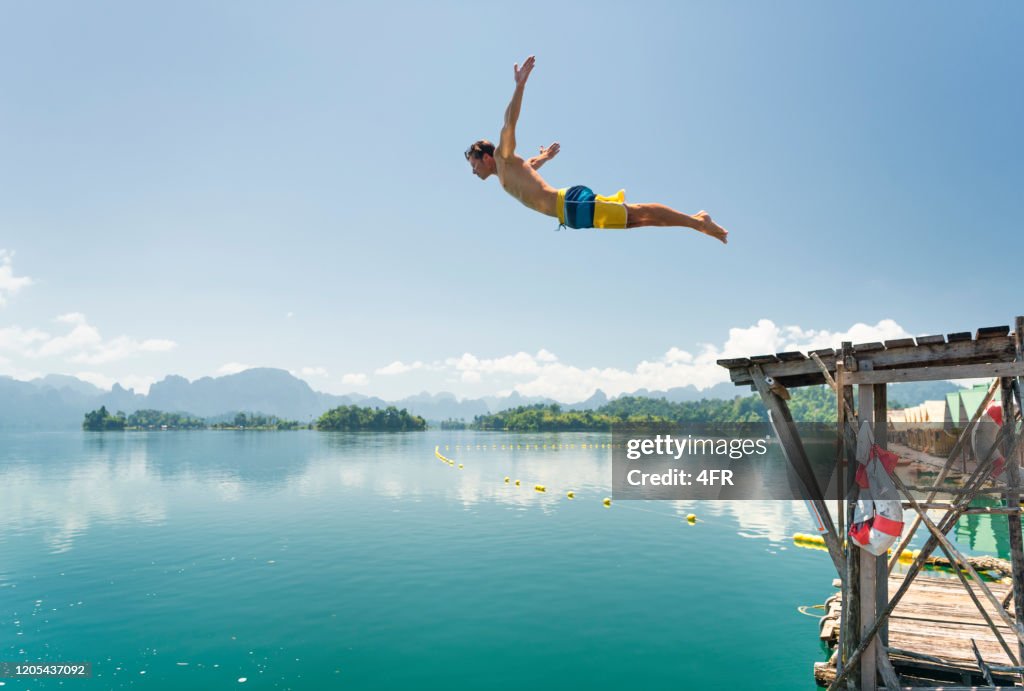 Jumping in the clear Lake Ratchaprapha, Khao Sok National Park, Thailand