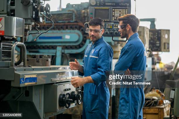 engineer leader and new technical staff explain to using cnc milling machine at production line facility . - train driver stock pictures, royalty-free photos & images
