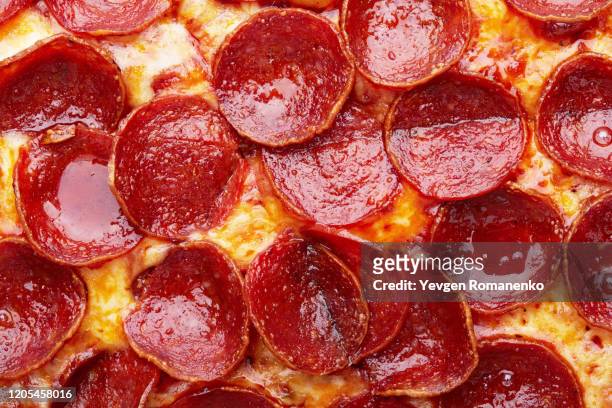 closeup of pepperoni pizza as a background - salami stock pictures, royalty-free photos & images