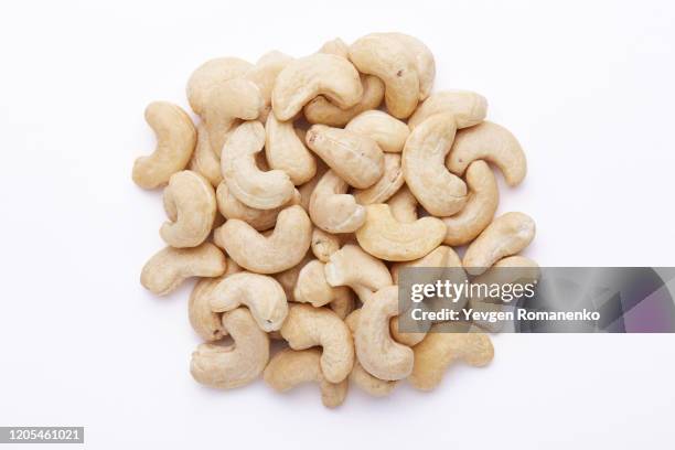 cashew nuts isolated on white background - cashew ストックフォトと画像