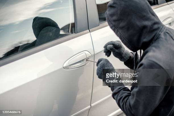 man stealing a car - thief stock pictures, royalty-free photos & images