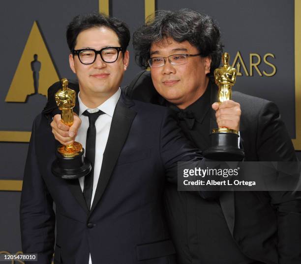 Jin Won Han and Bong Joon Ho pose with Their Awards for Original Screenplay inside The Press Room of the 92nd Annual Academy Awards held at Hollywood...