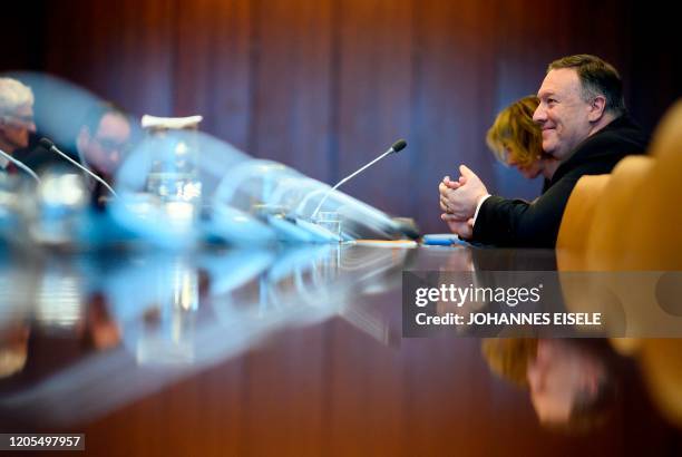 Secretary of State Mike Pompeo smiles as he meets United Nations Secretary-General Antonio Guterres at the New York UN Headquarters on March 6, 2020...
