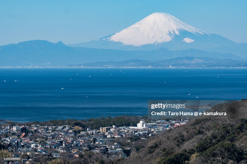 Snowcapped Mt. Fuji and residential district by the sea in Kanagawa prefecture of Japan