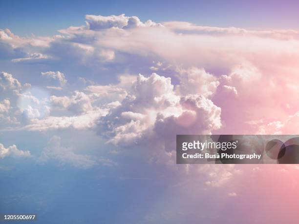 pastel colored clouds, view of the sky from aircraft - dreamlike stock pictures, royalty-free photos & images