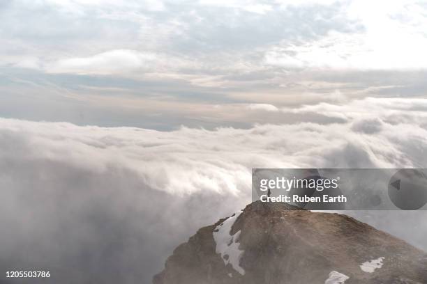 beautiful view from the top of a mountain a woman looking at the awesome cloud scape from above - los angeles film festival screening of everything beautiful is far away stockfoto's en -beelden
