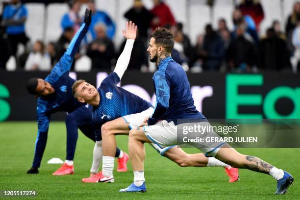 Marseille's French defender Jordan Amavi, Marseille's French defender Valentin Rongier and Marseille's Argentine forward Dario Benedetto warm up...