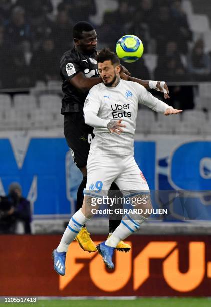 Amiens' Ghanaian defender Nicholas Opoku vies with Marseille's Argentine forward Dario Benedetto during the French L1 football match between...