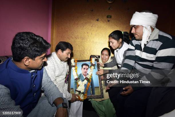 Delhi BJP President Manoj Tiwari, along with other party colleagues seen with family members of Intelligence Bureau officer Ankit Sharma, at Khajuri...