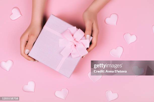 pink gift box in hands - luxary stock pictures, royalty-free photos & images