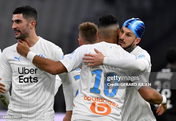 Marseille's French midfielder Dimitri Payet is congratulated by Marseille's Argentine forward Dario Benedetto and Marseille's Spanish defender Alvaro...