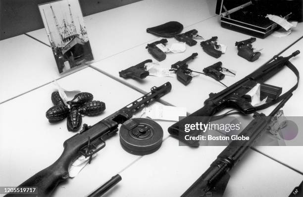 Seized weapons, including automatic rifles, hand-guns, hand grenades and rocket warheads from the Gloucester fishing trawler Valhalla are displayed...