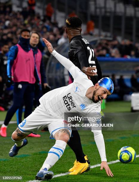 Marseille's Argentine forward Dario Benedetto vies with Amiens' Cameroonian defender Aurelien Chedjou during the French L1 football match between...