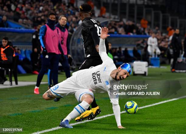 Marseille's Argentine forward Dario Benedetto vies with Amiens' Cameroonian defender Aurelien Chedjou during the French L1 football match between...