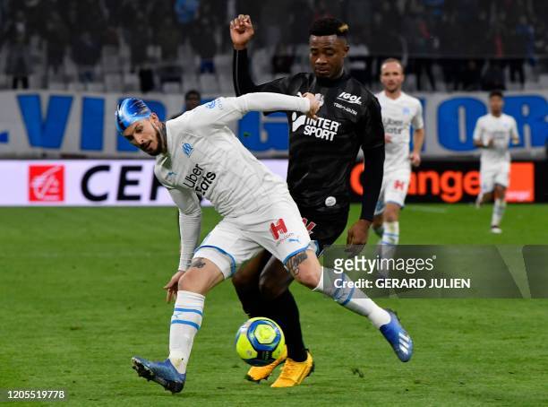 Marseille's Argentine forward Dario Benedetto fights for the ball with Amiens' Cameroonian defender Aurelien Chedjou during the French L1 football...