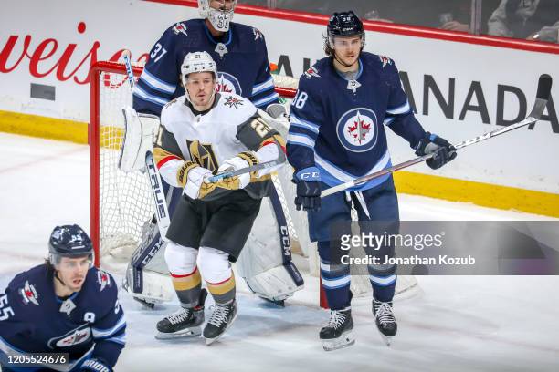 Nick Cousins of the Vegas Golden Knights and Nathan Beaulieu of the Winnipeg Jets keep a eye on the play during first period action at the Bell MTS...