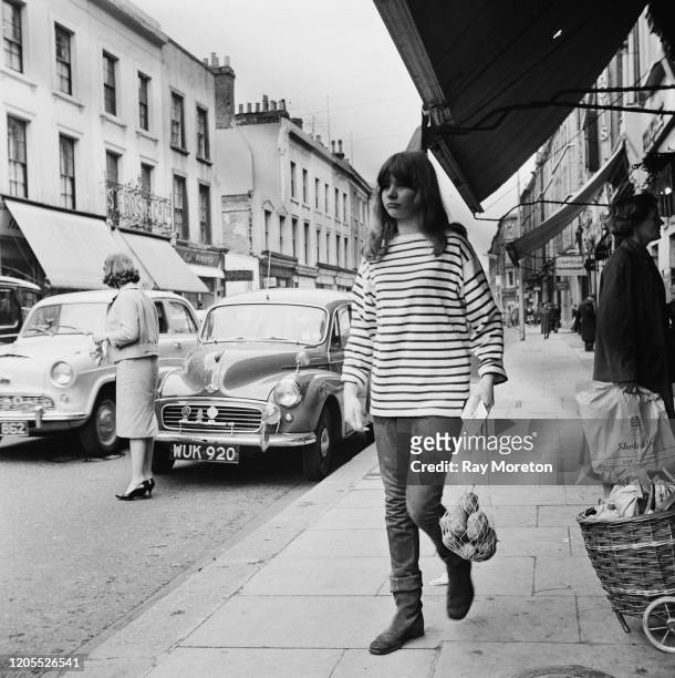 Young woman wearing a Breton striped top in the fashionable style associated with the Chelsea bohemian set, London, September 1959. The contemporary...