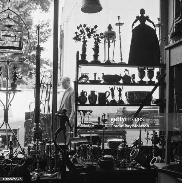 Objects in the window of an antique shop in Chelsea, London, September 1959.